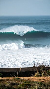 Powerful ocean waves crashing on the shore with white foam and spray.