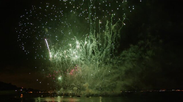 Amazing fireworks show footage. Exploding colorful sparks and flames in the night sky. 