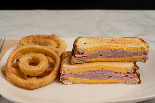 sliced ham melt sandwich  with nion rings