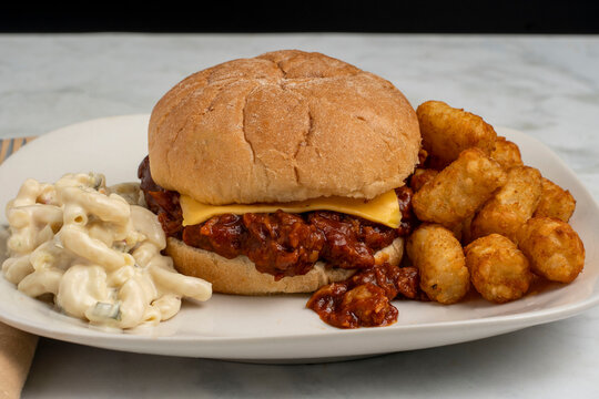  pulled pork  sandwich  with macaroni salad  and tots