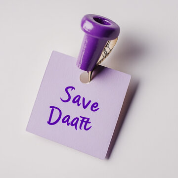 Purple sticky note with save date text pinned by a purple push pin announcement reminder stationery background selective handwritten celebration