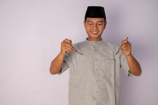 A Young Man in Traditional Attire with Spoons Preparing for an Entertaining Performance