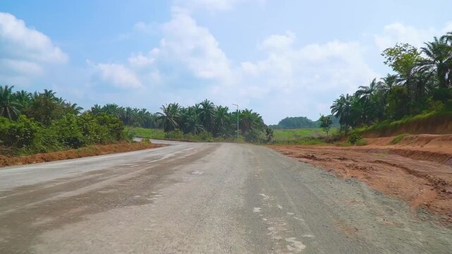 Open Unpaved Dirt Access Road Stretching Through Rural Palm sawit Plantation Area Remote Countryside Transport Route Regional Industrial Land Development Infrastructure Concept