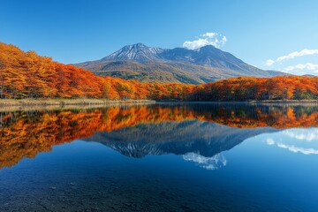Obraz premium Autumn lake reflection with colorful forest and mountain, peaceful nature landscape and fall season scenery.