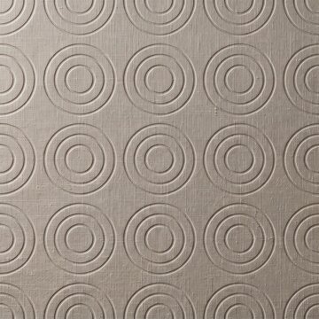 A repeating pattern of debossed concentric circles on a textured beige fabric surface background with embossed onto textured symmetrical minimalist