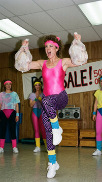 Retro aerobics class with women in colorful 80s attire, one holding turkeys, representing retro fitness and humorous throwback themes
