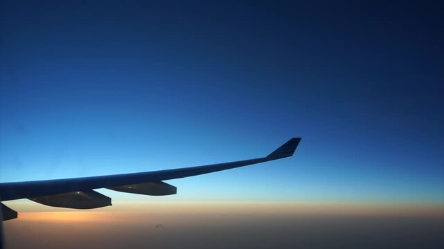 Airplane Wing Silhouette Flying Through Sunset Sky View From Window High Altitude Flight Journey Commercial Aviation Travel Concept Horizon Background Scenic View Passenger Seat Perspective