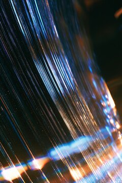 Abstract fiber optic cable texture background with bright blue light glow