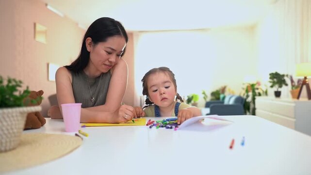 Japanese mother and daughter drawing together at home