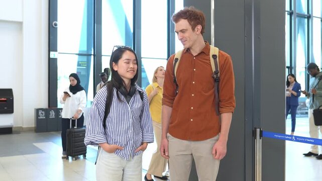 Young multicultural couple talking at the airport terminal