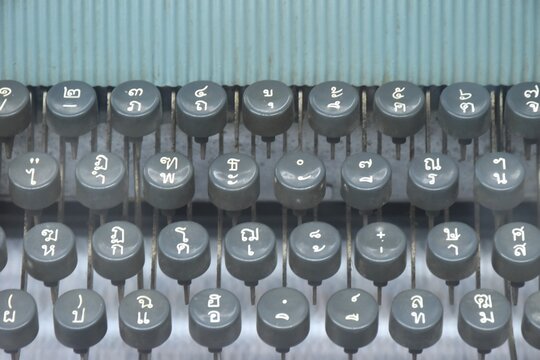 close up of manual typewriter with Thai letter language QWERTY background and texture