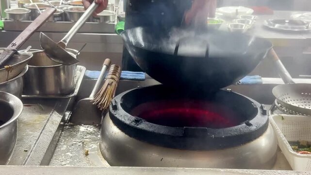 Hands Cooking Noodles and Vegetables in Wok &ndash; Chinese Restaurant Kitchen