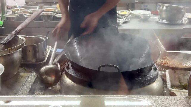 Hands Cooking Noodles and Vegetables in Wok &ndash; Chinese Restaurant Kitchen