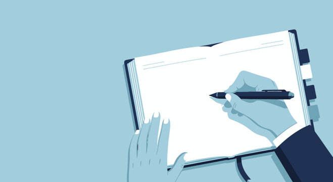 Hand writing in open notebook with pen and copy space