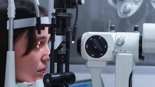 Young Female Optometrist Performing a Vision Test on a Young Female Client at an Eye Clinic