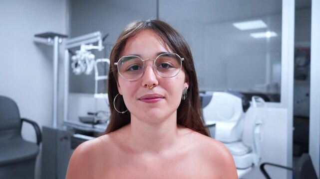 Young Woman Trying on Glasses in an Optical Clinic, Checking Her Vision with an Eye Chart