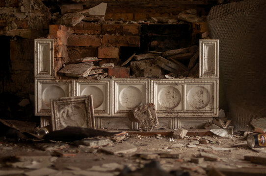 Abandoned overgrown mansion with spiral staircase, old car and ruined interior