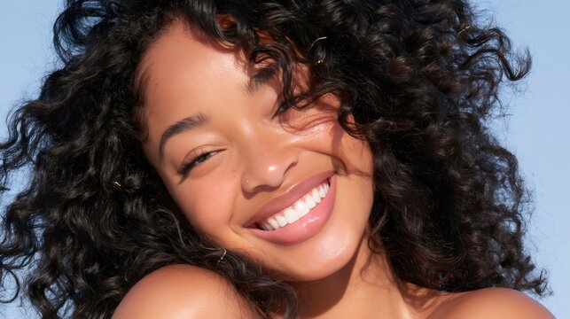 Beautiful young woman smiling with natural curly hair
