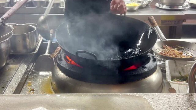 Hands Cooking Noodles and Vegetables in Wok &ndash; Chinese Restaurant Kitchen