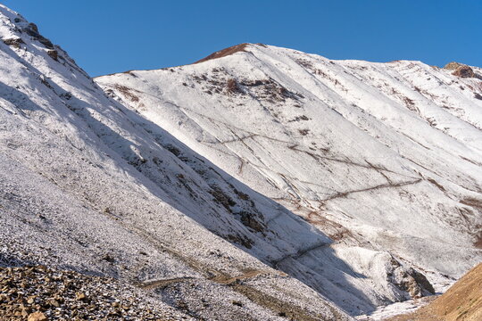 Snow-dusted trail toward Travelers Pass, Lenin Peak route in August