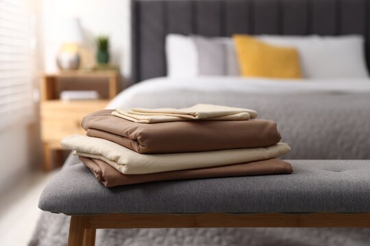 Fresh clean linens on bench at home, closeup