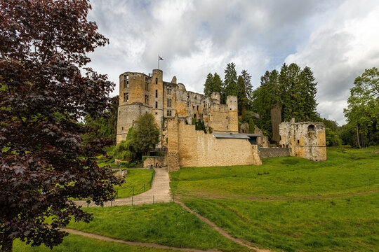 Medieval Beaufort Castle, a historic fortress surrounded by lush greenery in Beaufort, Luxembourg