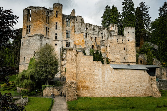 Medieval Beaufort Castle, a historic fortress surrounded by lush greenery in Beaufort, Luxembourg