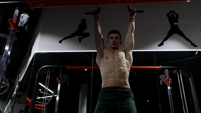 Shirtless sportsman with muscles torso in the gym. muscular sportsman do abs workout. exercise for abs sixpack torso muscle. sporty man training abs. sixpack exercise by hanging leg raises. workout