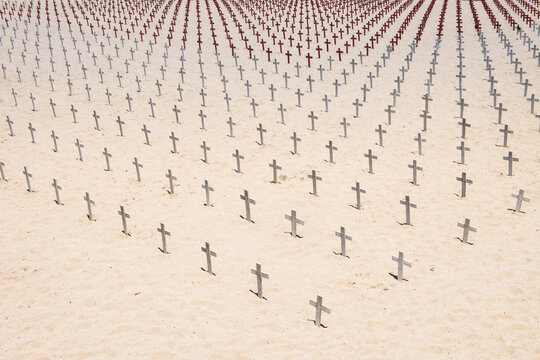 Aerial view of the temporary weekly Arlington West Memorial with crosses lined up on a sandy beach, Santa Monica, California, USA