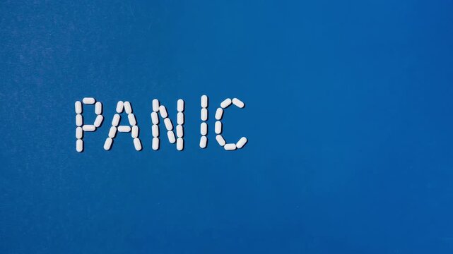 viral pandemic abstract white pill capsules spelling out pandemic on blue background