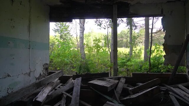 The interior of the destroyed room. Broken walls and debris are visible inside the wooden house.