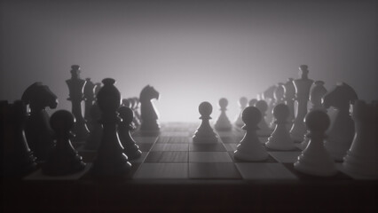 Chess pieces in starting positions facing each other, backlit with a hazy atmospheric monochrome effect. © Piotr Adamczyk