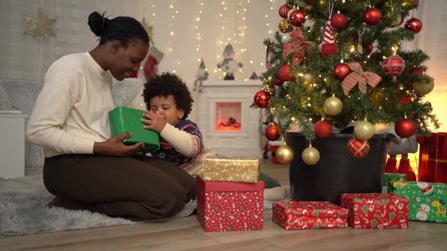 African American mother and son celebrating Christmas together at home