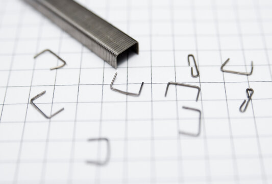staples on cross-section sheet of paper