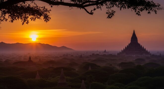 Serene sunset view overlooking a valley of ancient temples with dark tree silhouettes and violet skies