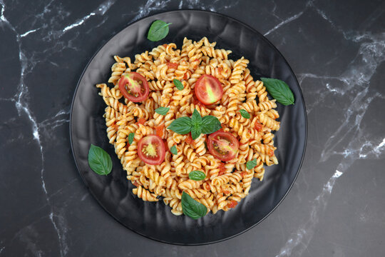 fusilli pasta with tomato sauce and basil