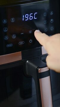 Vertical view of setting parameters and turning on a modern air fryer display