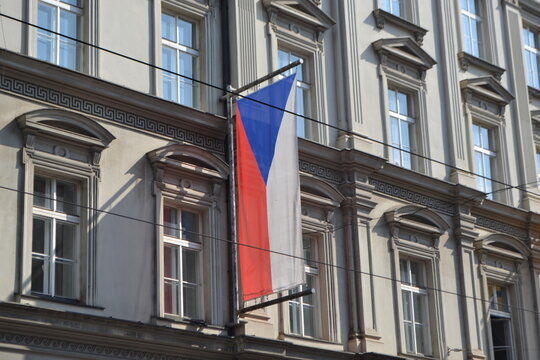 Czech republic flag hanging on classical building facade in prague for patriotic banner and travel background
