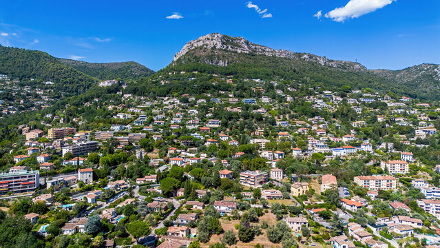 Aerial drone view of the residential hillsides of Vence with the majestic Baou de Saint-Jeannet peak in the background, France