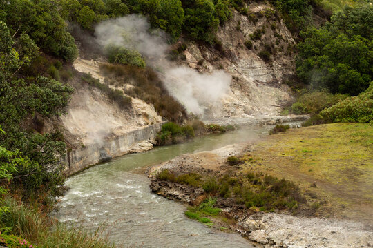 A river flows through the geothermal landscape of steaming springs and fumaroles in Furnas.