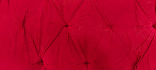 Obraz premium Red velvet tufted fabric texture background with luxury upholstered furniture pattern