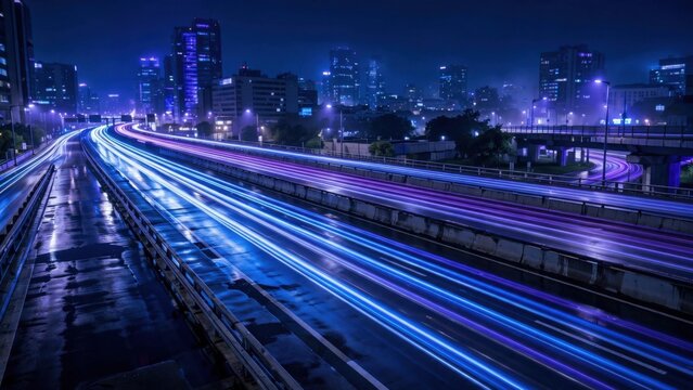 Streak of glowing lights paints a wet, urban highway at night