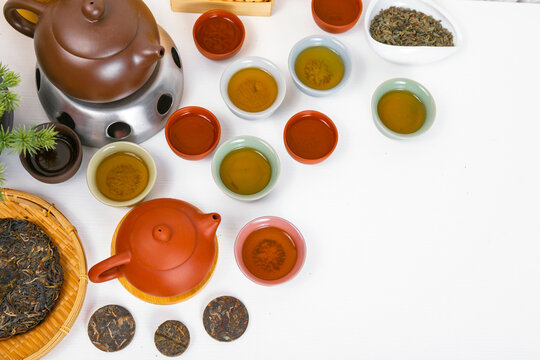 Traditional Chinese tea ceremony with Yixing clay teapot and puerh tea on wooden table. Authentic Asian tea set presentation with ceramic cups and bamboo tray for herbal tea drinking