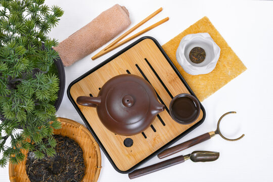 Traditional Chinese tea ceremony with Yixing clay teapot and Chaban bamboo tea tray. Authentic Asian puerh tea presentation flatlay. Healthy lifestyle and zen relaxation concept