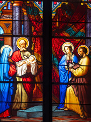 Fototapeta premium Stained glass depicting the presentation of Jesus at the temple.