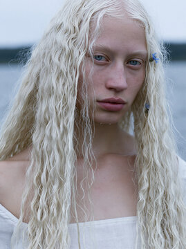 Haunting cinematic portrait of the Maiden of the Neman, an extraordinarily beautiful 23 year old Belarusian woman standing in the river