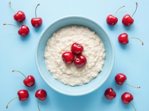 Delicious oatmeal with cherries on a blue background , Harvest picking season, Fresh healthy fruits.