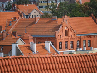 Red roof tiles and a red brick facade © andsyphoto