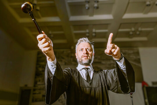 Judge Raising Gavel and Pointing Finger in Dramatic Courtroom Announcement