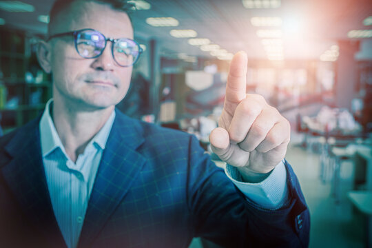 Businessman Touching Virtual Screen with Finger in Modern Office